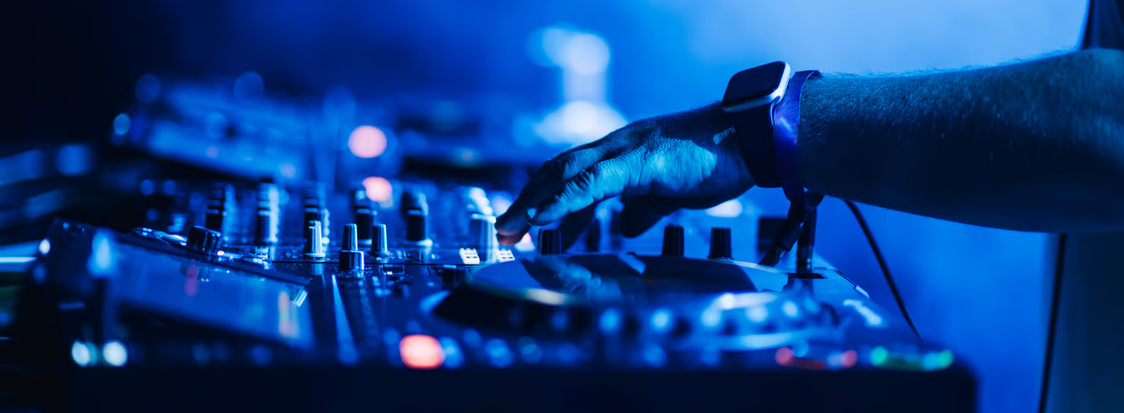A DJ performing for a dancing crowd while receiving live song requests through Requestify